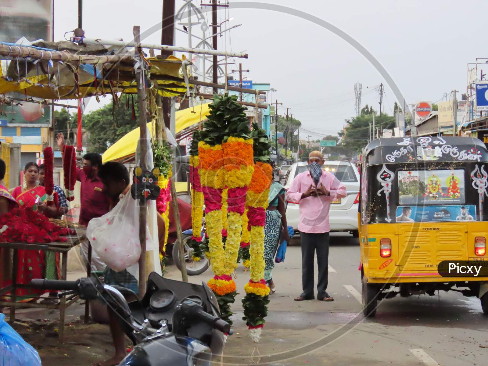 On The Road In The Morning, A Businessman Selling Flower Garlands Near The Temple Was Transacted Near The Shop And The Traditional Artwork On Vehicle