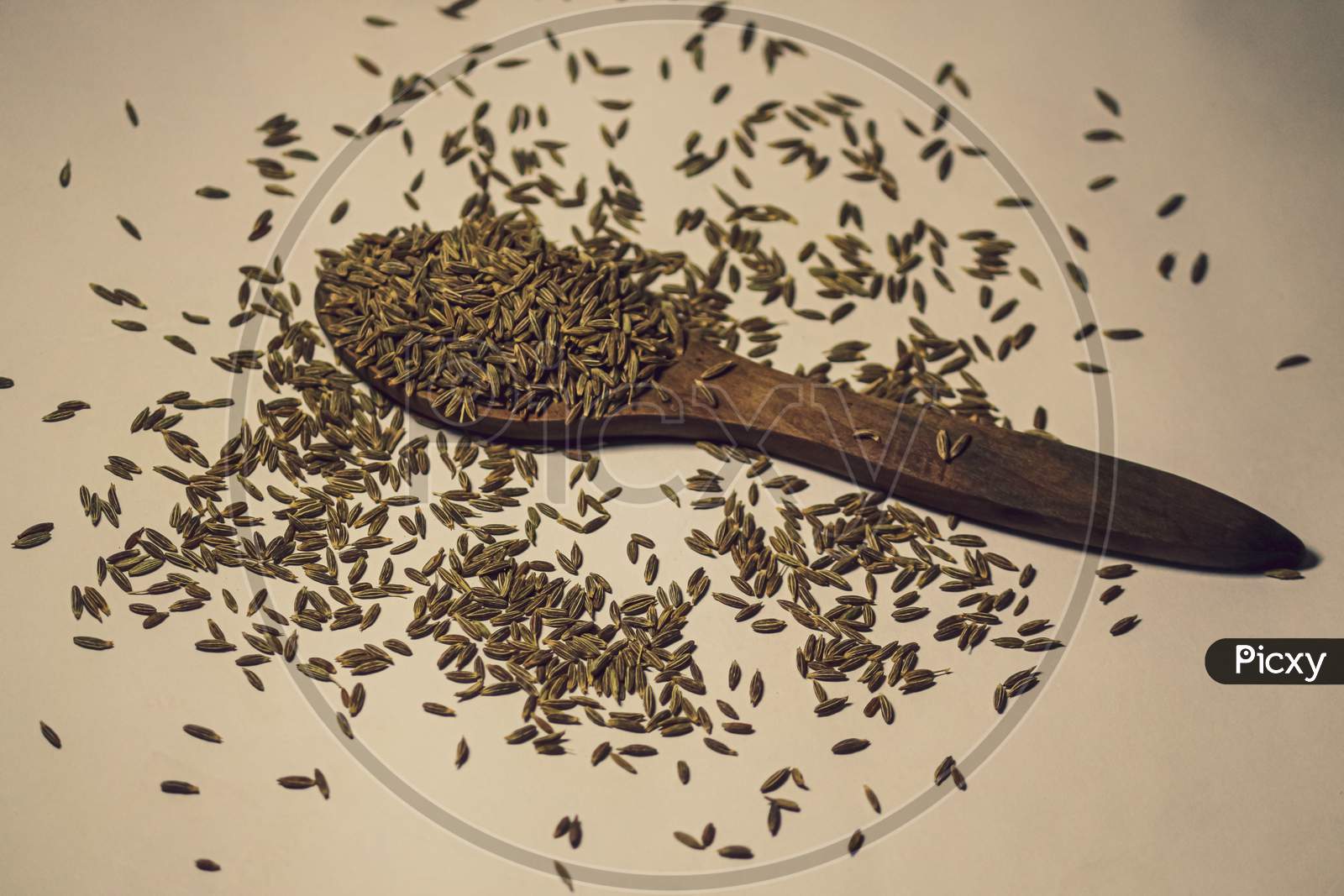 A spoon of full of healthy tasty beneficial cumin seeds