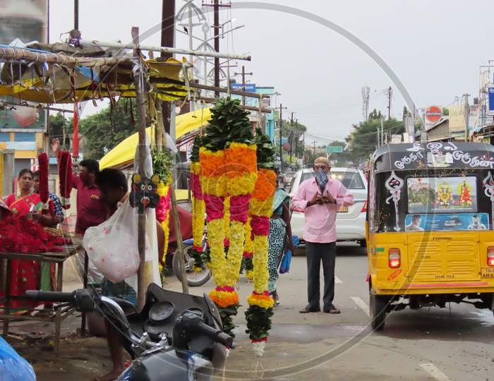 On The Road In The Morning, A Businessman Selling Flower Garlands Near The Temple Was Transacted Near The Shop And The Traditional Artwork On Vehicle