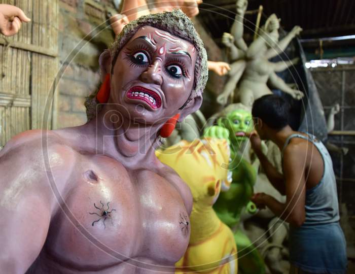 An artist finishing Asura where Durga idols are being prepared ahead of the biggest Hindu festival Durga puja in Nagaon District of Assam on Oct 9,2020