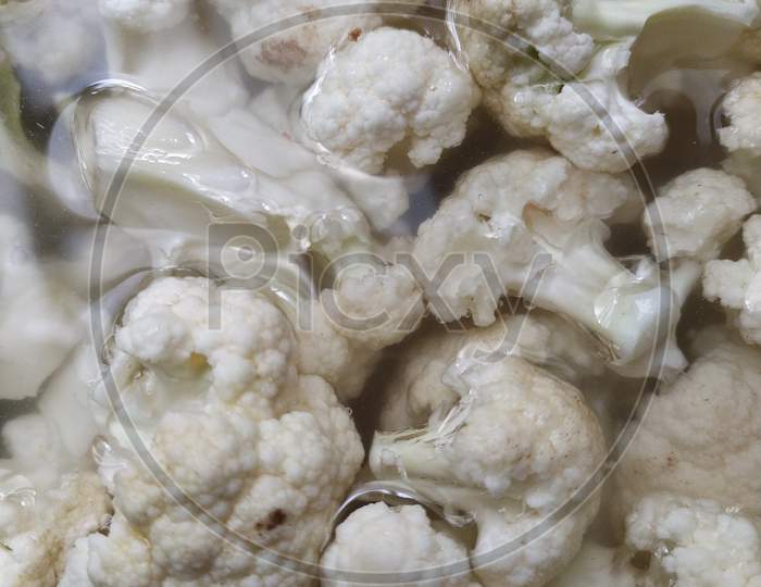 Closeup View Of Chopped And Rinsed White Cauliflower , Over Head View