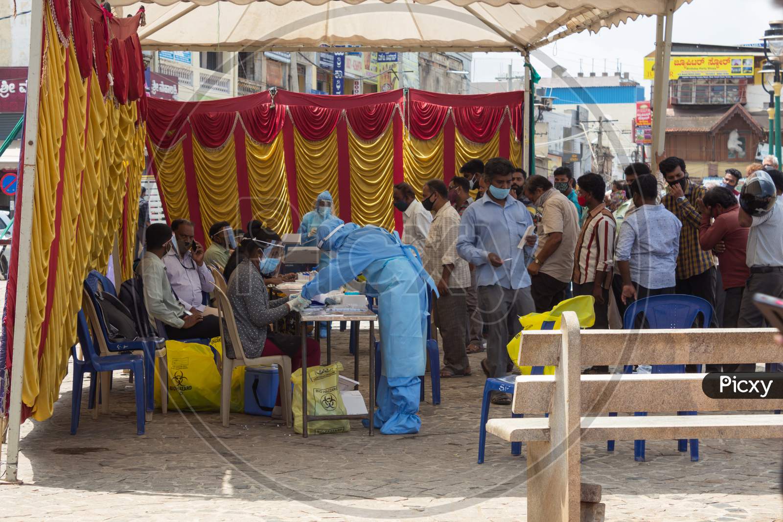 General Public are seen standing in a queue during Midday to get the Covid 19 test done  at a testing tent in Mysuru,Karnataka/India.