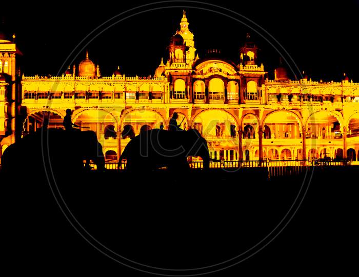 A Silhouette Picture of Royal Elephants walking in front of the Royal Ambavilas Palace during Dasara festival in Mysuru of Karnataka/India.