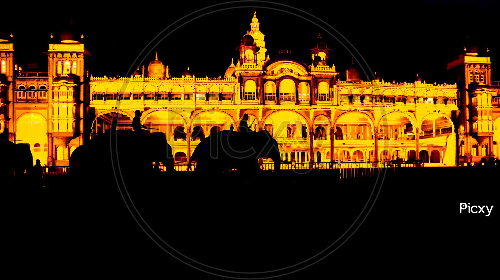 A Silhouette Picture of Royal Elephants walking in front of the Royal Ambavilas Palace during Dasara festival in Mysuru of Karnataka/India.