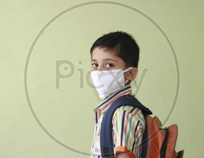 Kid getting ready for school after lock down. Kid eager to go to school after lock down. Indian Kid with mask and preparing for school