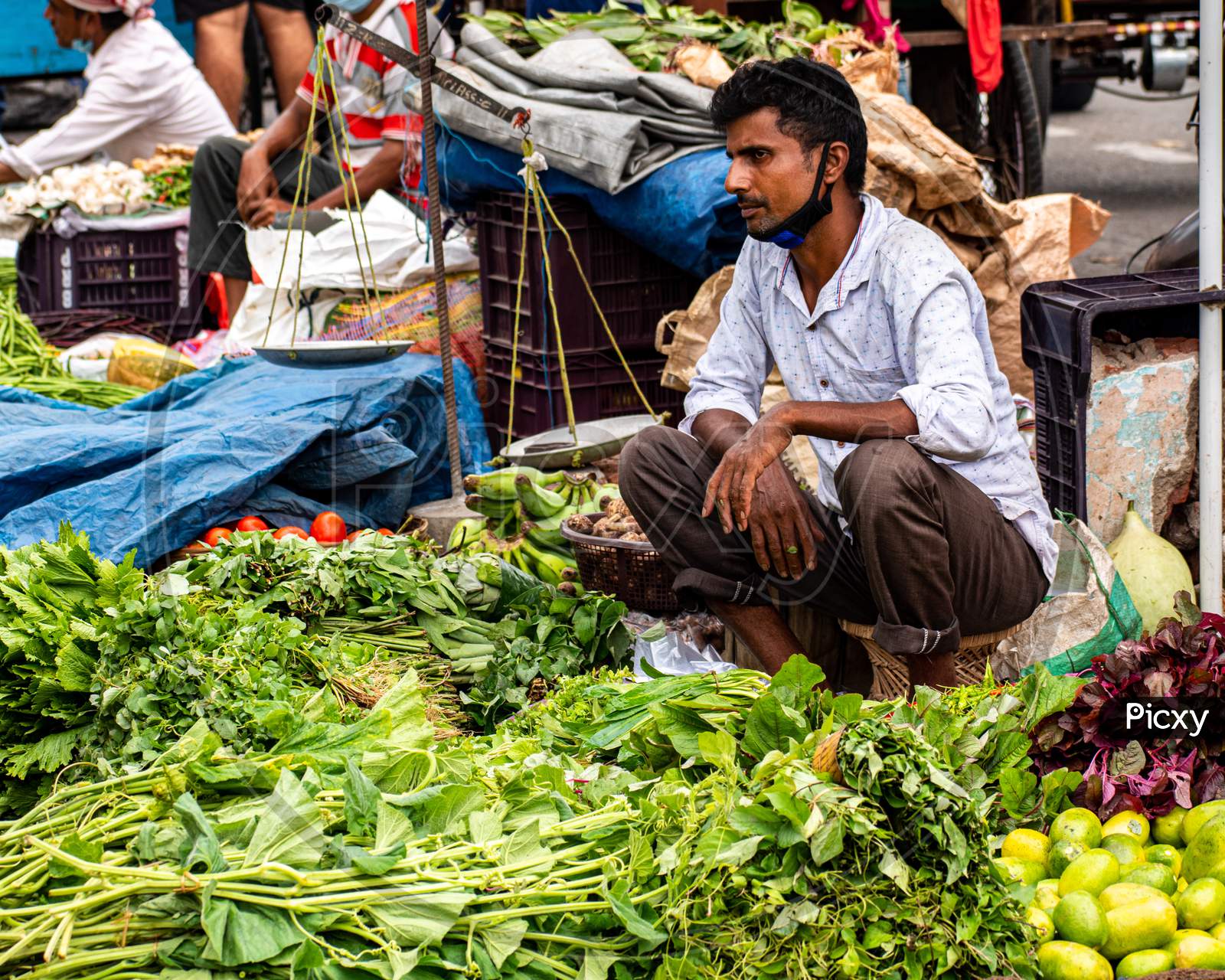 An unidentified vendor selling vegetables in weekly market