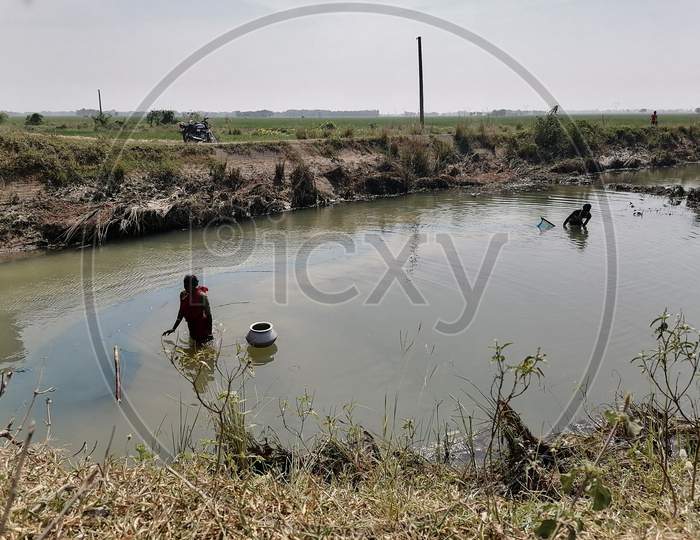 The man is fishing in Drain