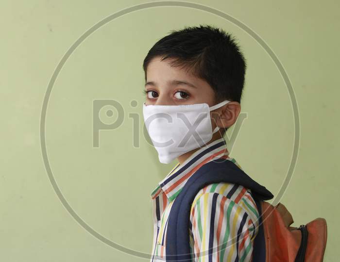 Kid getting ready for school after lock down. Kid eager to go to school after lock down. Indian Kid with mask and preparing for school
