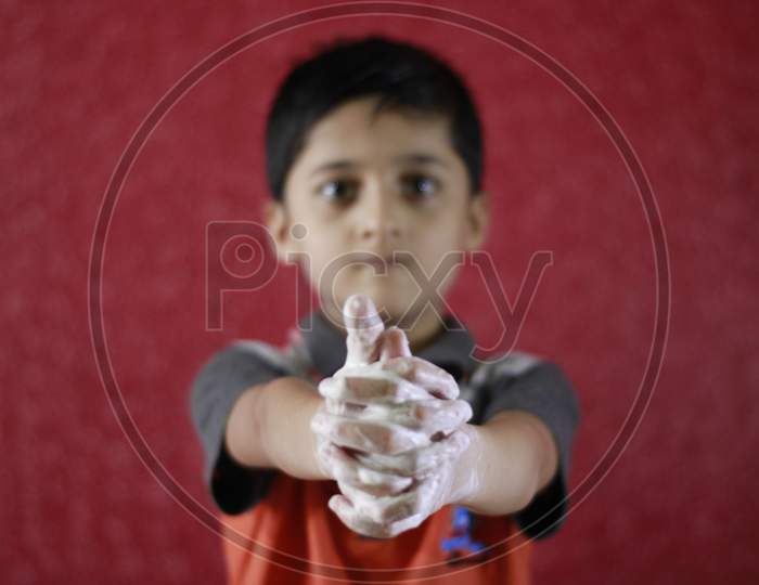 Asian Little Boy washing hands with water and soap. Hands Hygiene and virus infection prevention. Little boy explaining importance of washing hands with soap to prevent virus infection.