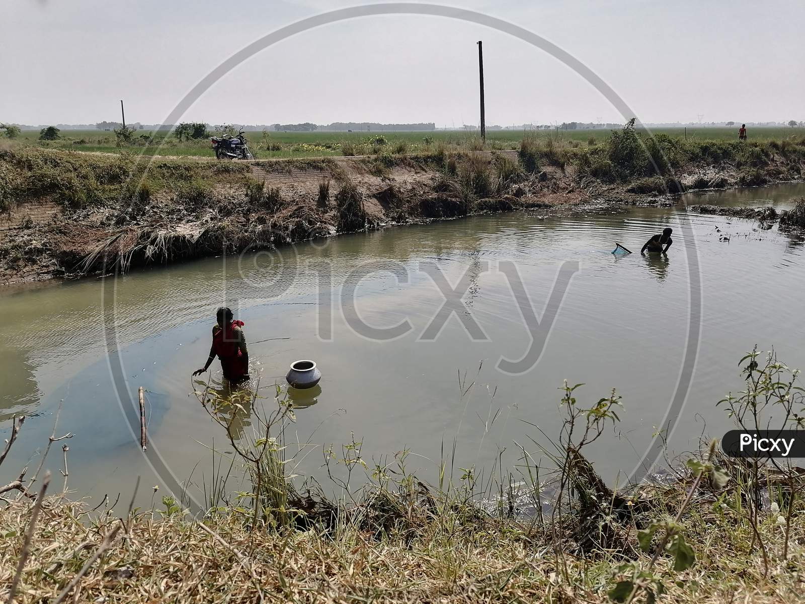 The man is fishing in Drain