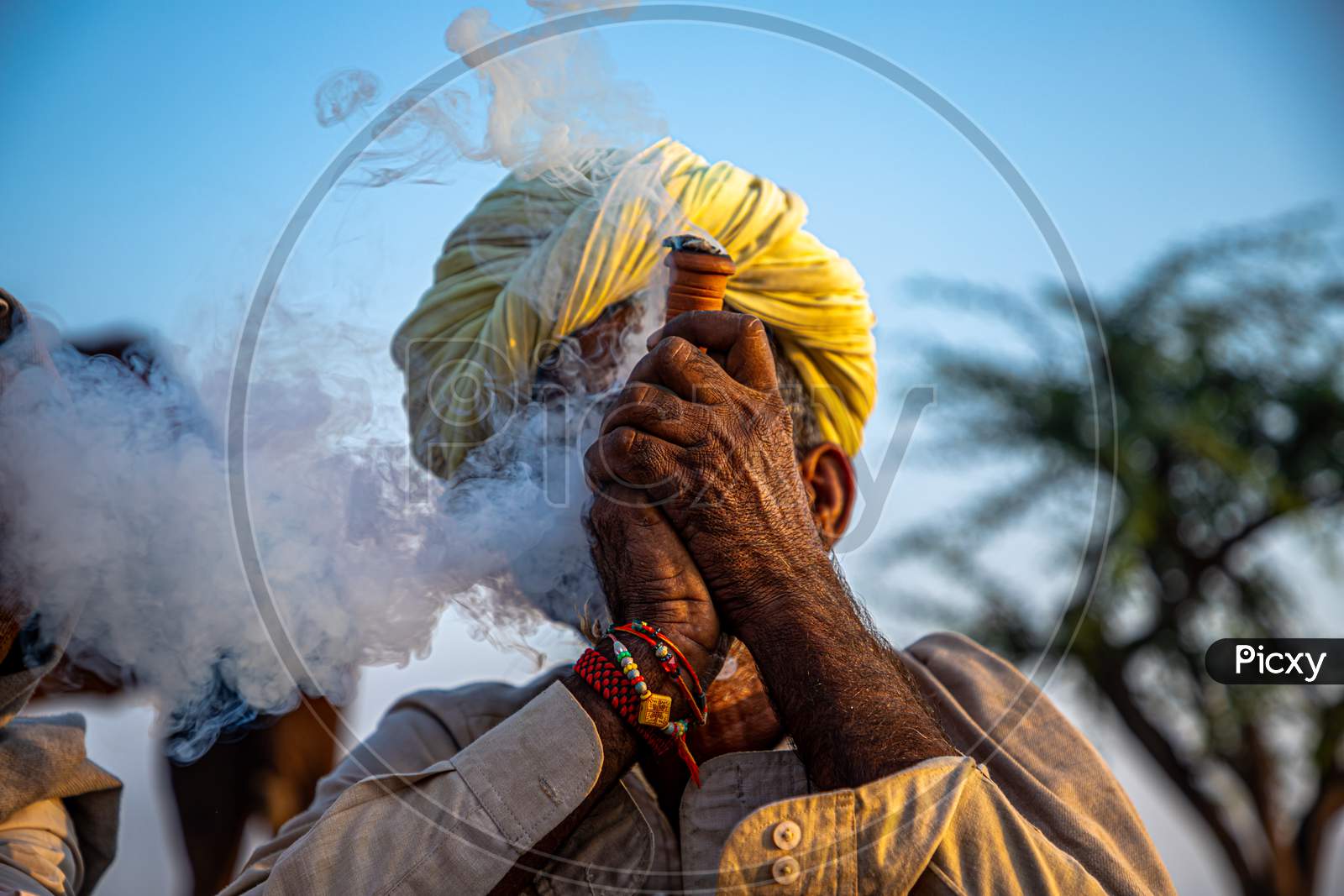 A Rajasthani Tribal Man Smoking Chillam At Pushkar