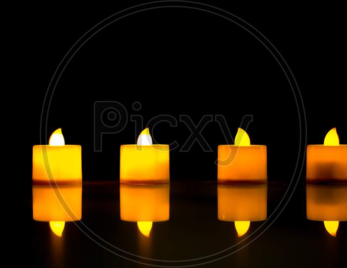 A Beautiful view of aesthetically arranged Electric Candles and their reflections against the  dark background for the Diwali festival of Lights in India.