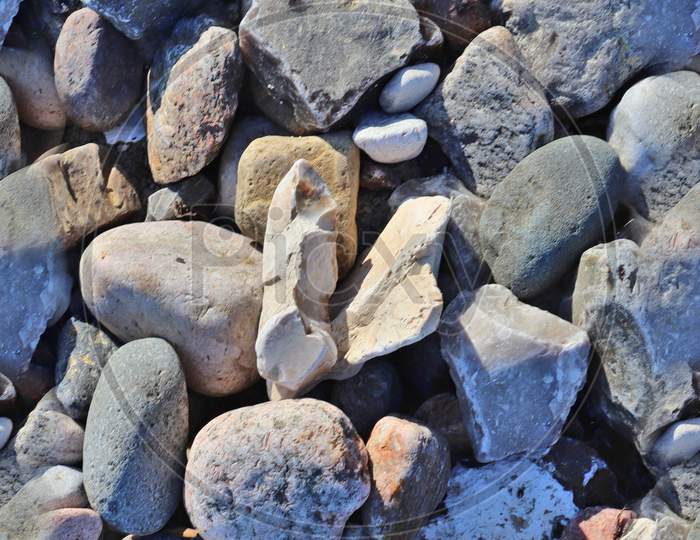 Photo Realistic Seamless Texture Pattern Of Pebbles And Stones At A Beach