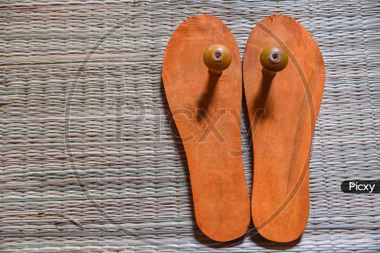 A closeup pair of wooden Indian traditional padukas or footwear for Hindu priests and Brahmins.