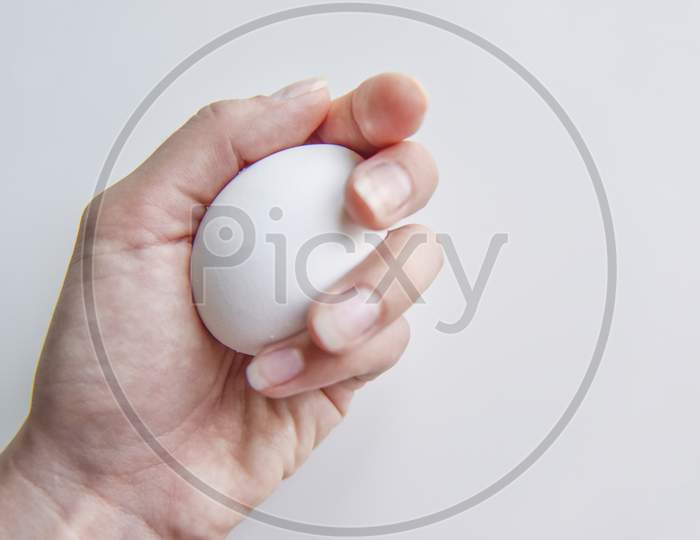 Selective Focus At The White Egg In The Hand
