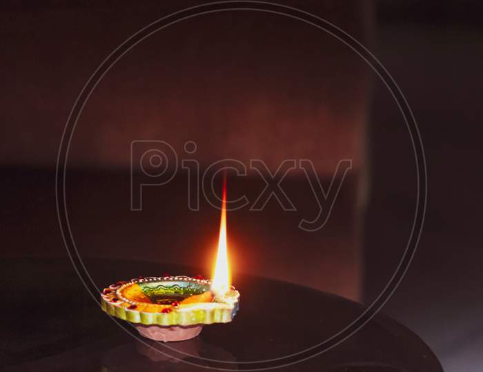 A burning oil small lamp flame in the dark for Diwali, Christmas, new year, celebration, occasion
