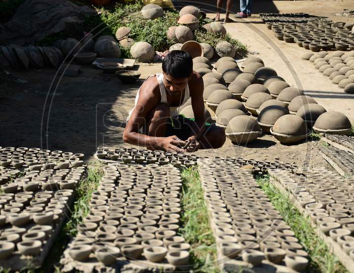 A  Potter arranging  earthen  lamps being sun dried for upcoming Diwali festival at Rupohi village in Nagaon District of Assam on Nov 10,2020.