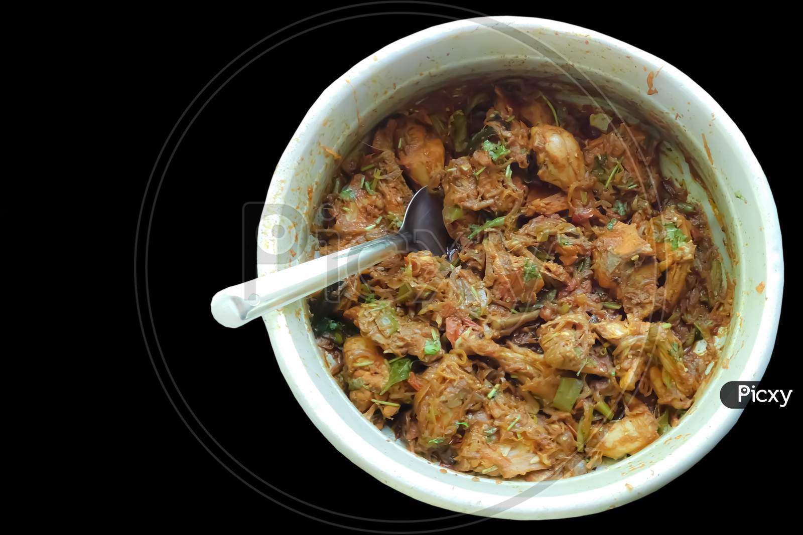Delicious Chicken Dry Curry In A Bowl With Spoon Black Background