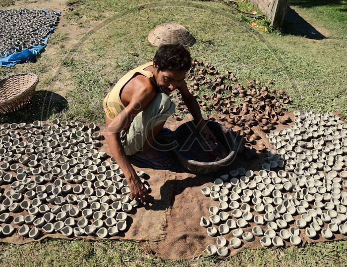 A  Potter arranging  earthen to be sun dried for upcoming Diwali festival at Rupohi village in Nagaon District of Assam on Nov 10,2020.