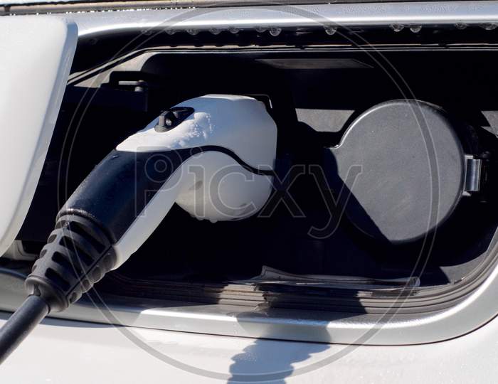 Ev Car Or Electric Car At Charging Station With Power Cable Plugged