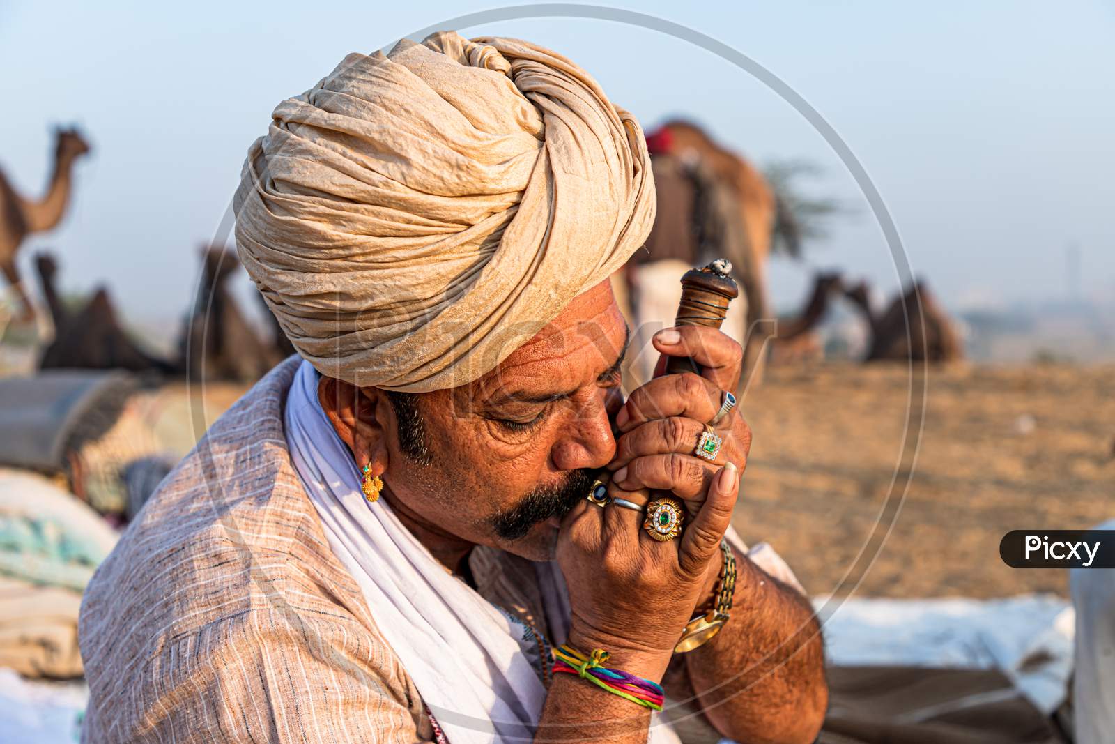 A Rajasthani Tribal Man Smoking Chillam At Pushkar Camel Festival