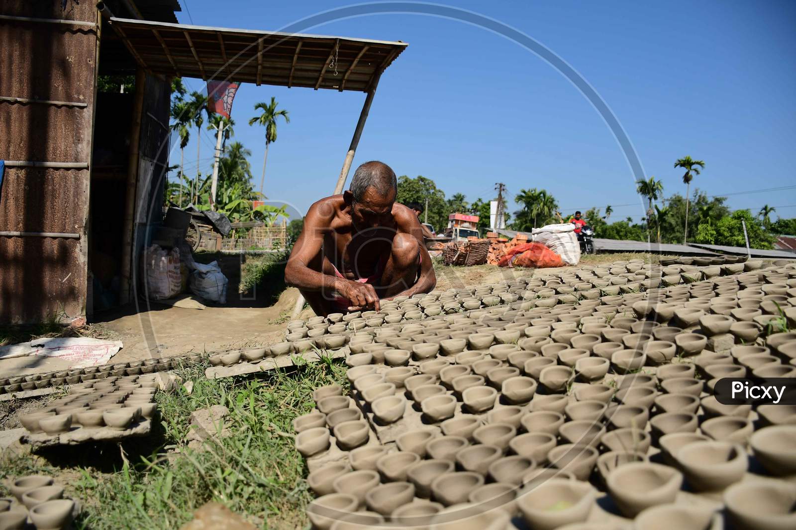 A  Potter arranging  earthen  lamps being sun dried for upcoming Diwali festival at Rupohi village in Nagaon District of Assam on Nov 10,2020.