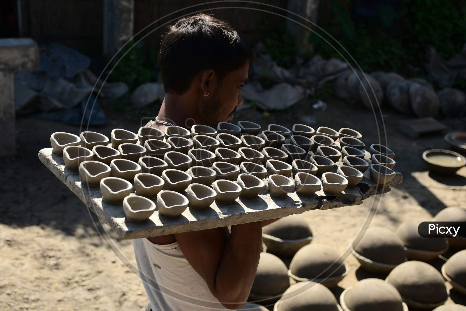 A  Potter making  earthen lamps ahead of Diwali festival at Rupohi village in Nagaon District of Assam on Nov 10,2020