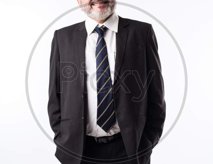 Closeup Portrait Of A Confident Indian Asian Mature Businessman Against White Background