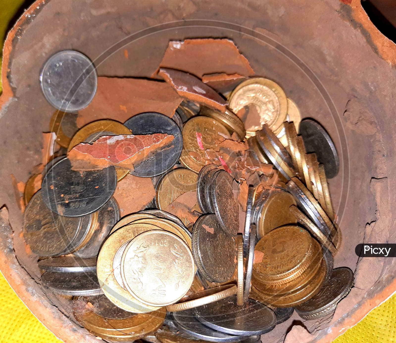Coin inside Broken clay pot