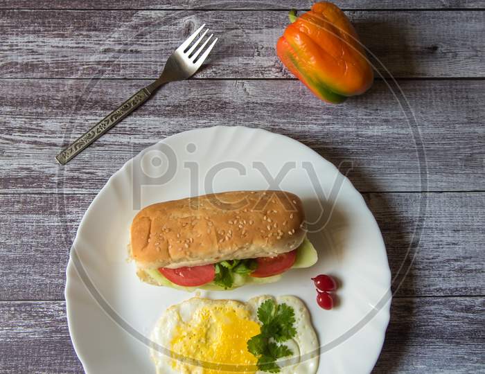 Top view of hot dog sandwich and fried eggs