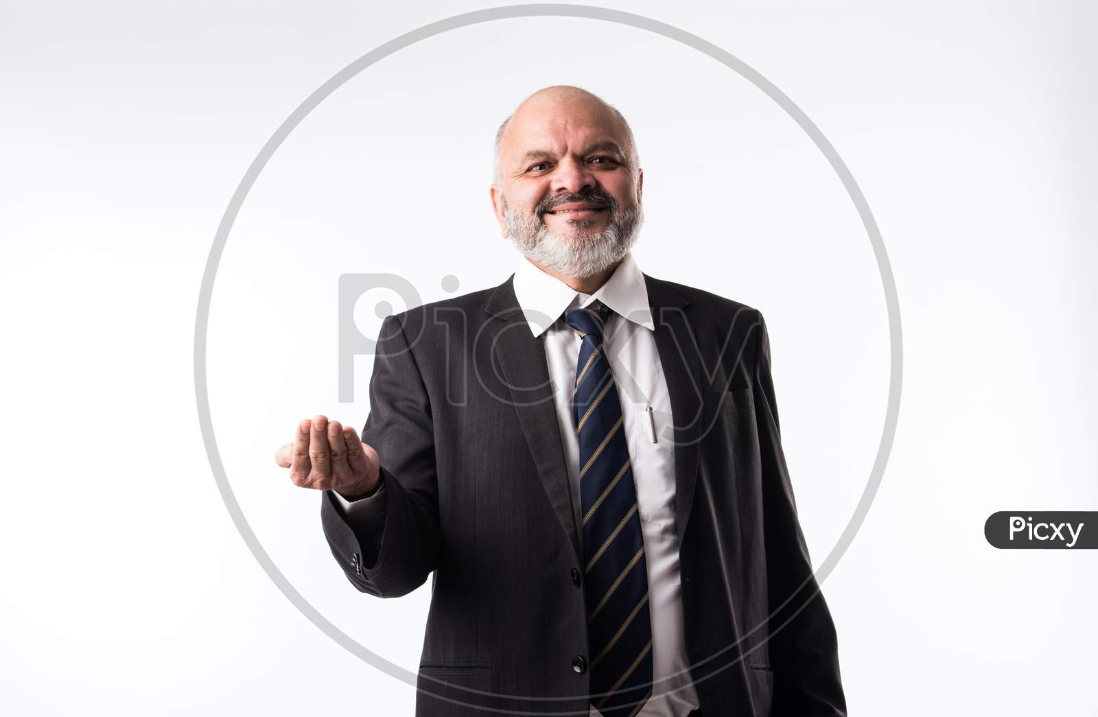 Middle Aged Indian Asian Businessman Pointing Finger And Presenting Empty Space