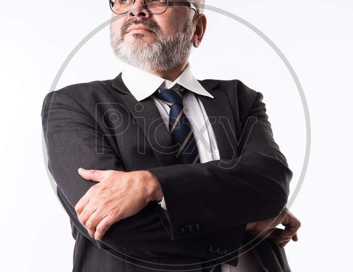Closeup Portrait Of A Confident Indian Asian Mature Businessman Against White Background