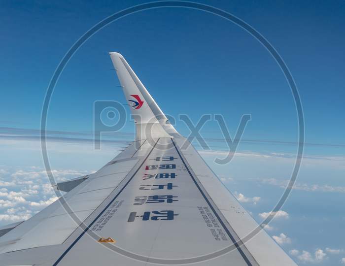 Wing Of An Airbus A321 Airplane Of China Eastern Airlines With Sky Background