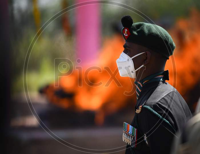 A soldier stands guard at the funeral of soldier Ryada Mahesh, 26, from Telangana's Nizamabad district, who was martyred in the encounter along with three others at Machil sector of Kupwara district in Jammu and Kashmir on Sunday.
