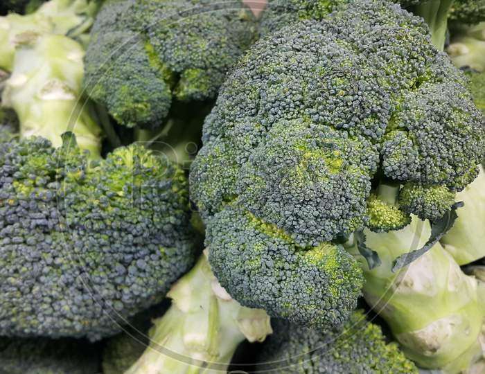 Green Fresh Broccoli Pile Placed In Market For Sale.