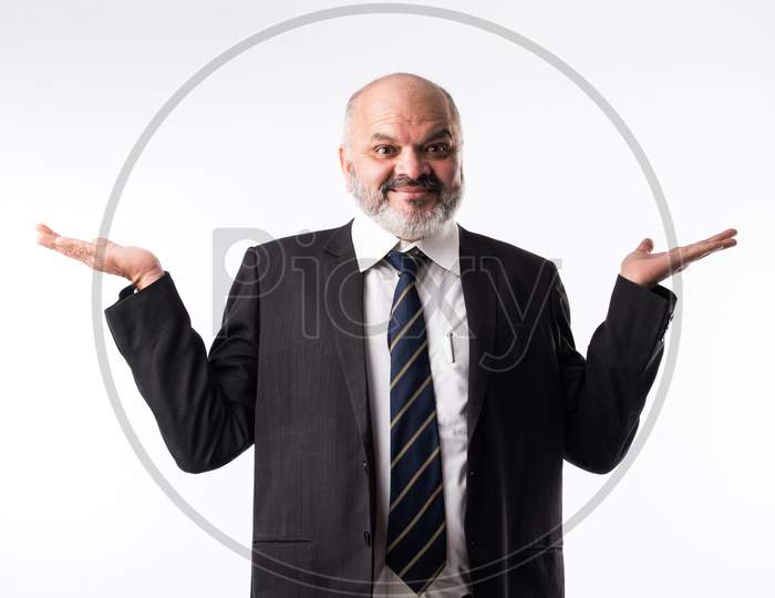 Middle Aged Indian Asian Businessman Pointing Finger And Presenting Empty Space