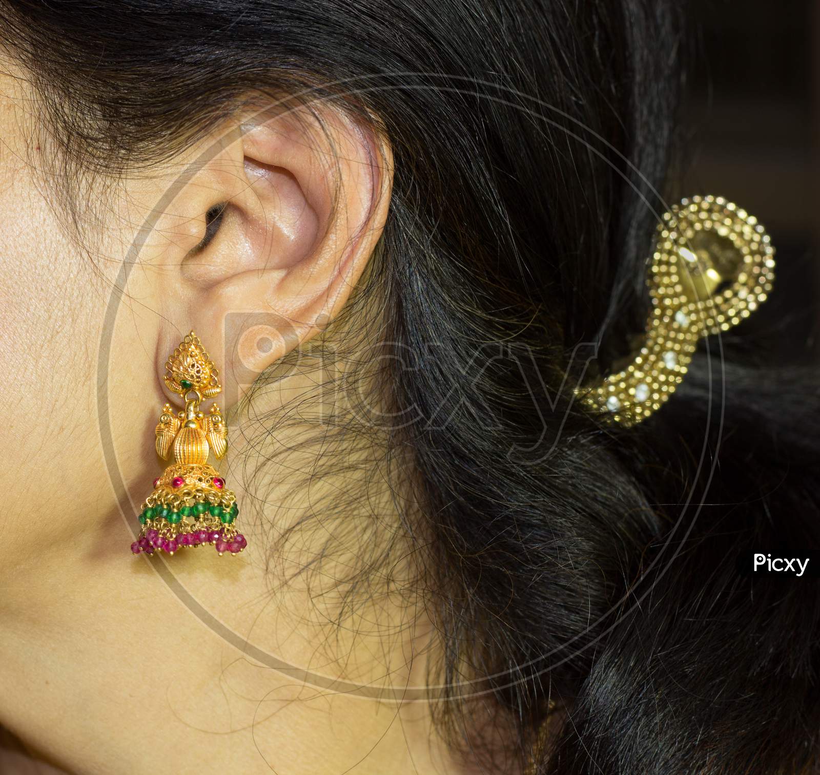 A close up view of a Indian Lady wearing Traditional Earrings for the Diwali festival of Lights.