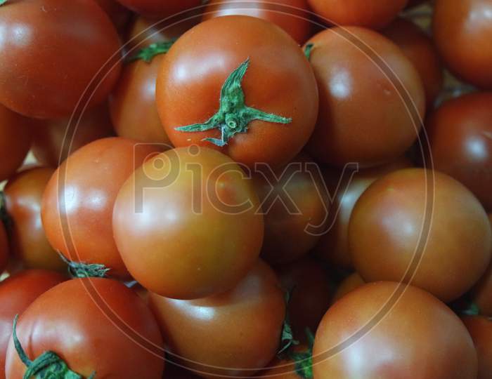 Close-Up View Of Red Tomatoes In Market For Sale