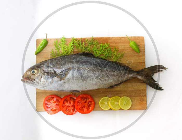 Fresh Butter Fish/Amberjack Fish/Allied Kingfish (Seriola Dumerilli) Decorated With Herbs And Vegetables, White Background.Selective Focus.
