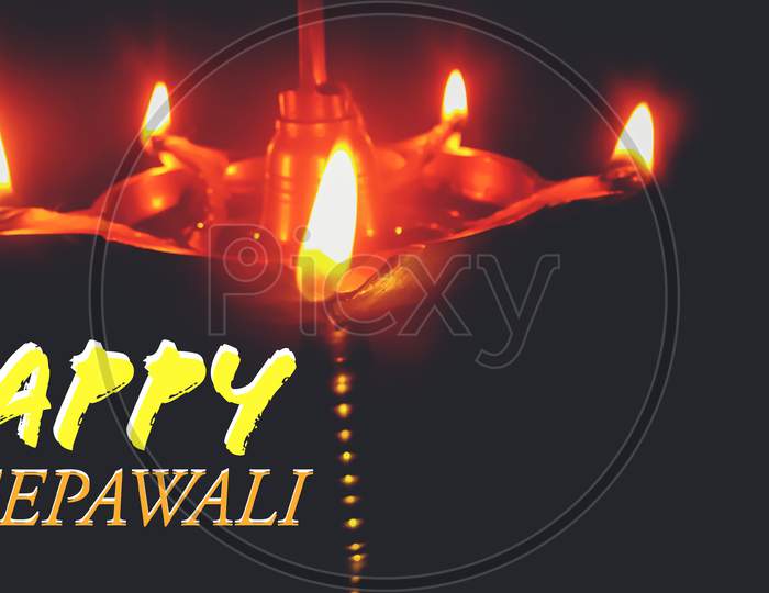 Realistic oil Lamp and Happy Deepawali Text On Dark Background,Can Be Use As Poster, Banner And More.