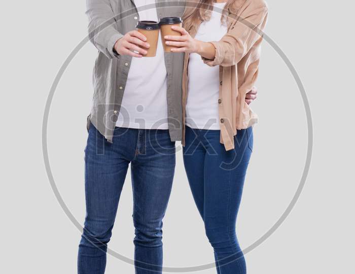 Couple Holding Coffee Cups Isolated. Couple Standing And Holding Coffee To Go Cup. Man And Woman Hugging, Lovers, Friends, Couple Concept.