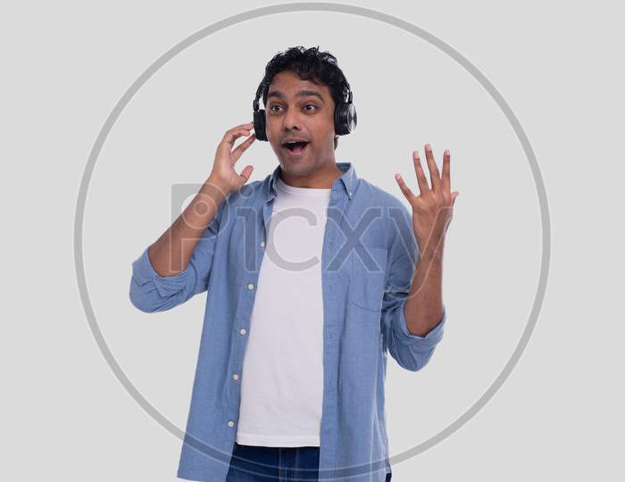 Indian Man Listening To Music From Phone Singing To It. Man Singing To The Music. Man Suprised By Music