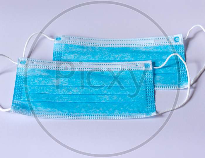 Two Surgical Protective Face Masks Isolated On A White Background
