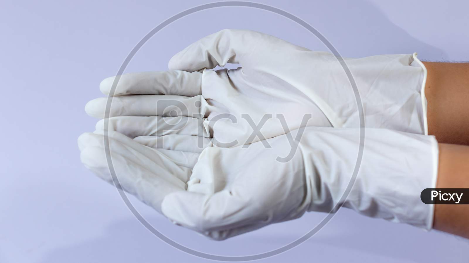 Female Doctor Wearing Medical Latex Gloves In Both Hands Together