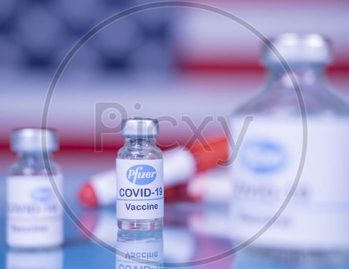 Maski, India - Nov 12,2020 : Pfizer Biontech Vaccination To Protect Against Coronavirus Covid-19 Disease With Us Flag As Background.