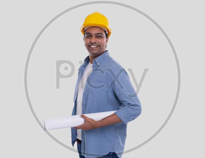 Construction Worker Holding House Plan In Hands. Architect Holding Blueprints. Yellow Hard Helmet.
