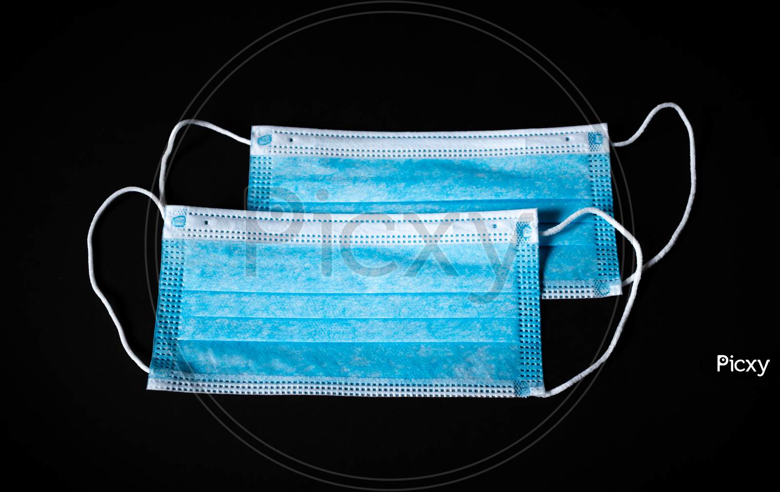 Two Surgical Face Masks In Black Background