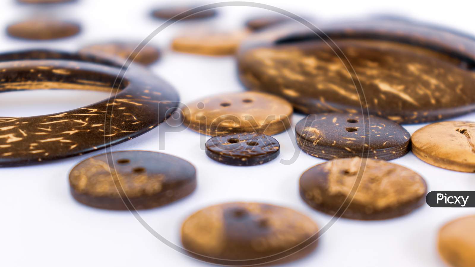 Coconut Shell Buttons Spreads Across White Background