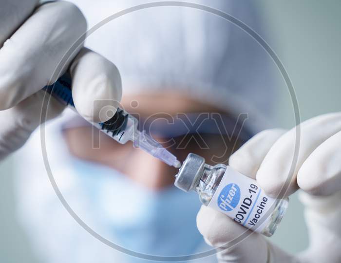 Maski, India - Nov 12,2020 : Doctor Holding Pfizer Biontech Vaccine And Syringe To Protect Against Coronavirus Covid-19 Disease.