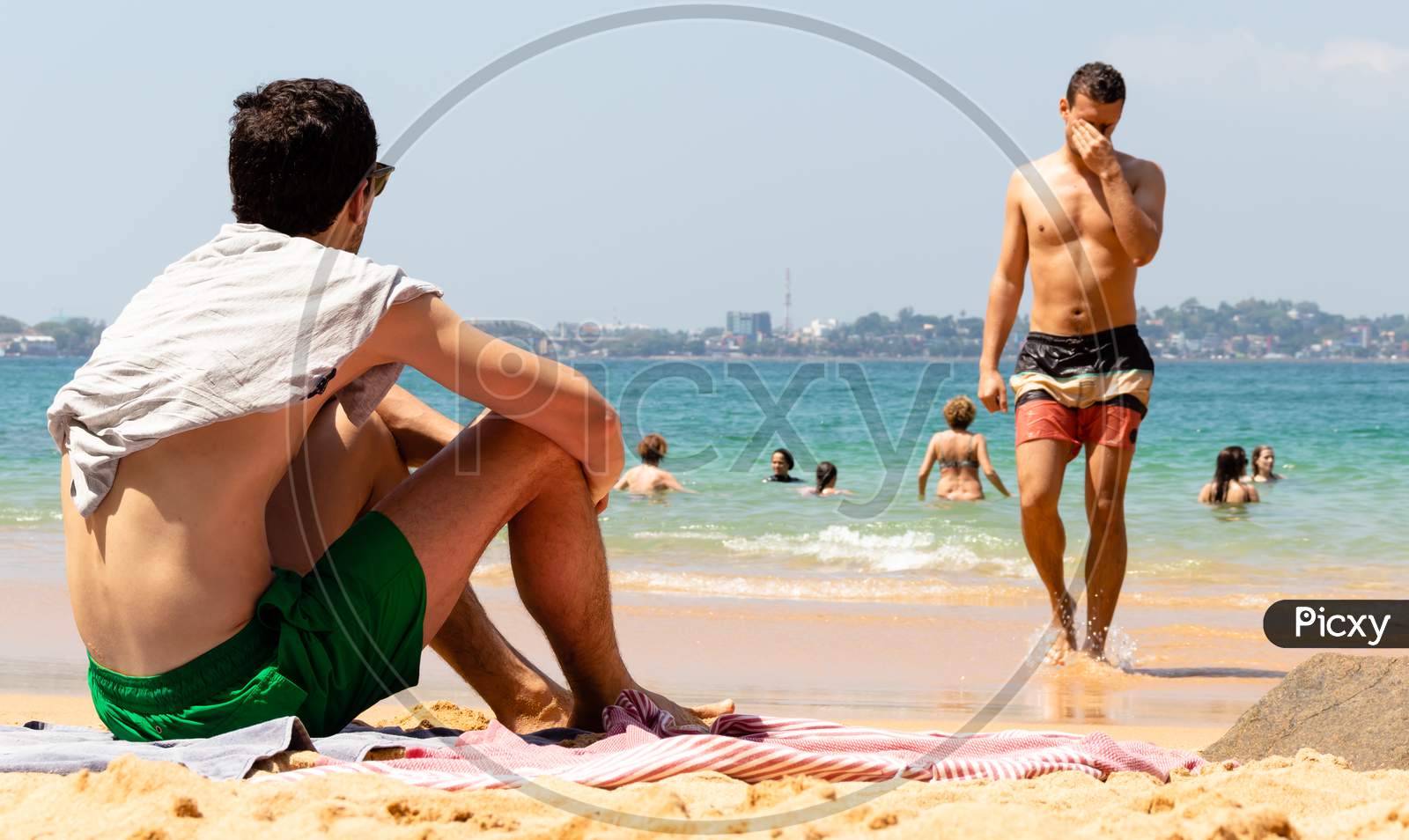 Young Male Sunbathing And Enjoying The View In The Picturesque Beach